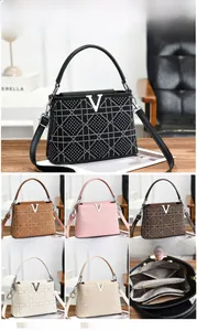 Detailed view of the internal zipper compartments and various color options for women handbag