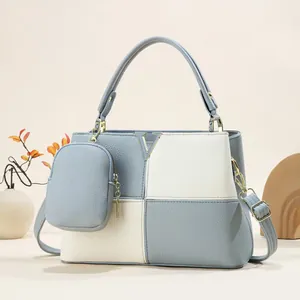 Detail of color-block leather handbag with V-logo, round handle and mini pouch charm