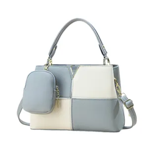 Minimalist color-block leather handbag in blue and white with metal V logo and crossbody strap