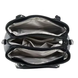 Interior view of black tote bag showing spacious compartments and grey herringbone lining