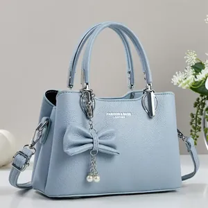 Light blue lychee pattern leather handbag with bow, pearl charms and silver hardware