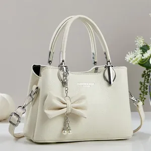 Creamy white lychee texture leather handbag with pearl bow charm and silver hardware