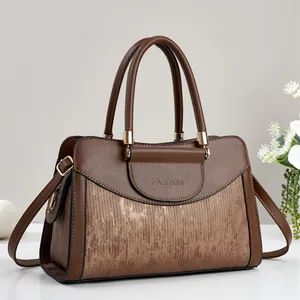 Elegant brown leather handbag for women featuring a metallic striped panel and gold hardware