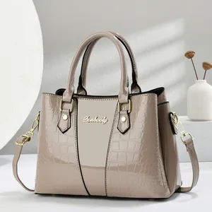 Elegant beige crocodile-embossed satchel with gold hardware and top handles