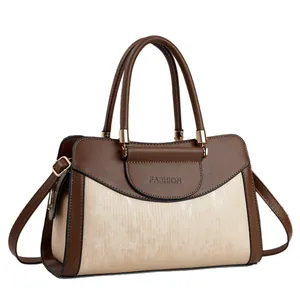 Elegant two-tone brown and beige handbag with gold hardware and top handle