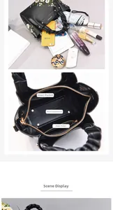 Detail view of large capacity black PU leather bag with embroidery and multi-pockets