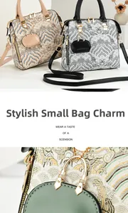 Detail of elegant Chinese embroidery handbag with matching mini pouch and gold hardware