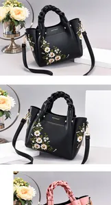 Detailed embroidery and gold metal hardware on high-quality women's crossbody bag