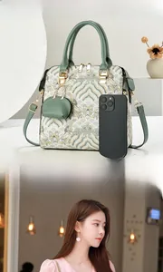 Close-up of vintage embroidered handbag with wavy jacquard pattern and mini pouch
