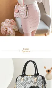 Close-up of pink and black vintage embroidery handbags with heart charms and cloud motifs