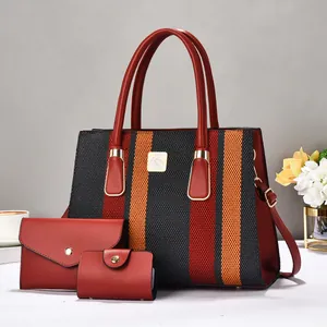 Three-piece women's tote set with red orange striped pattern and gold hardware details