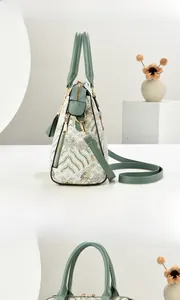 Detail of retro floral embroidery and side multi-zipper compartments on the handbag