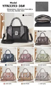 Detail view of stylish satchel bag with silk scarf handle and silver metal logo hardware