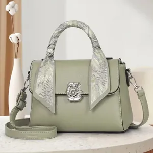 Retro sage green leather handbag with floral scarf handle and silver G-shaped clasp