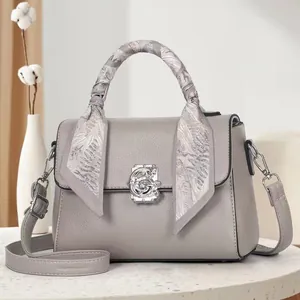 Chic grey leather tote bag with floral silver clasp and decorative silk scarf detail