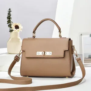 Detail of trendy khaki crossbody bag featuring lychee texture and gold metal twist lock