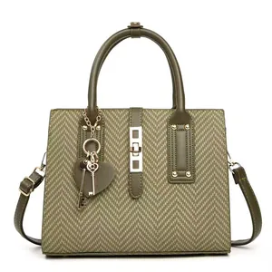 Olive green herringbone tote bag with gold hardware and heart keychain charm