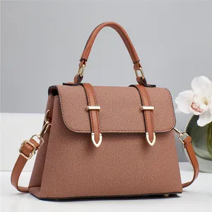 Brown textured fabric handbag with leather straps and gold hardware for women