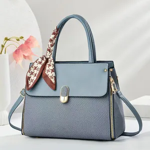 Light blue patchwork handbag with macaron tones, embossed texture and houndstooth scarf