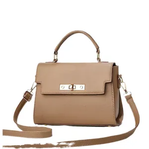 Brown faux leather crossbody bag with golden turn-lock and adjustable shoulder strap