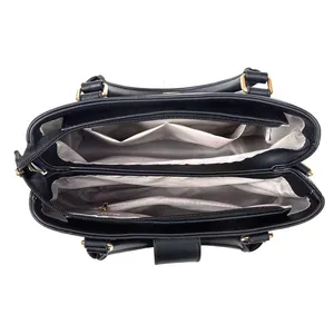 Detailed interior of the large black handbag showing compartments and fabric lining