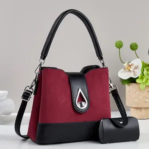 Chic burgundy and black patchwork handbag with silver hardware and mini cylindrical pouch