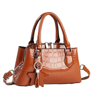 Caramel patent leather crossbody bag with crocodile embossing and star pendant charm