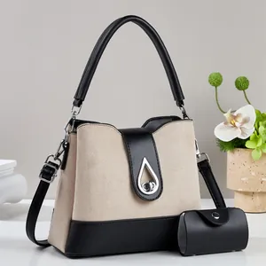 Fashionable beige and black bicolor handbag with adjustable shoulder strap and small pouch