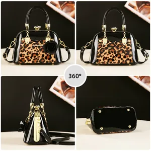 Detail view of leopard print shell bag with black patent leather and gold hardware