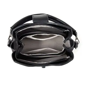 Interior view of black leather handbag with three large compartments and zipper pocket