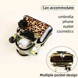 Detailed interior of leopard print shell bag showing multi-pocket storage and large capacity