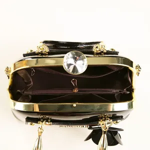 Detail view of the shell bag interior with golden metal frame and crystal clasp