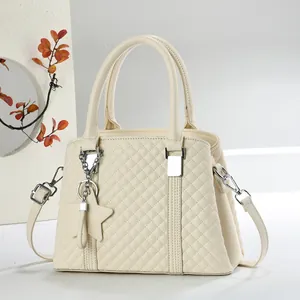 Elegante borsa trapuntata beige con ciondolo a stella e dettagli in argento su bianco