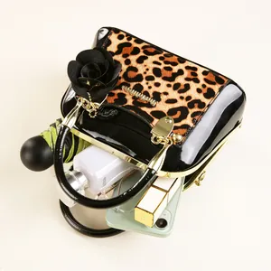 Internal view of leopard print shell bag showing space for phone and cosmetics