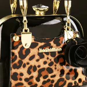Detail of leopard print shell bag with golden hardware and crystal top clasp