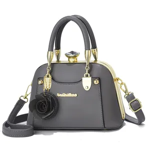 Detail of grey vintage shell bag featuring gold metal frame and crystal clasp buckle