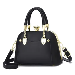Elegant black shell-shaped mini handbag with gold metal frame and crystal knob closure
