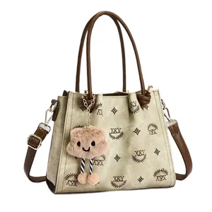 Vintage embroidered tote bag in beige canvas with X&Y pattern and brown leather straps