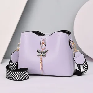 Lavender purple PU crossbody bag with black butterfly charm and zigzag woven strap