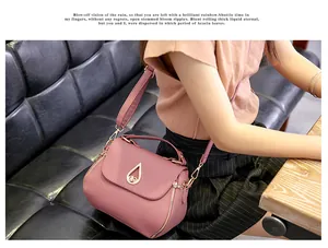 Detail of pink quilted PU leather crossbody bag with teardrop metal clasp and zip
