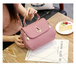 Detail of pink quilted PU leather handbag with gold drop twist lock and pearl zipper pull