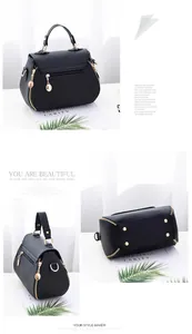 Detail view of black pebble leather handbag featuring gold hardware and metal feet