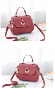 Detail of dark pink quilted leather handbag with golden teardrop lock and metal zipper side