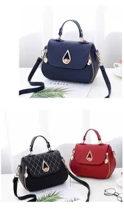 Close-up of quilted leather handbags with metal twist locks in navy, black and red