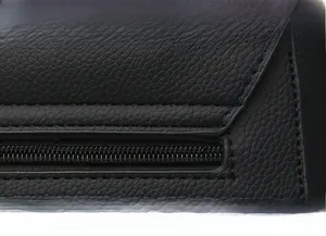 Detailed close-up of high-quality lychee pattern leather and precise stitching on black bag