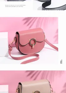 Detail of trendy saddle bags with unique cat ear metal locks and wide striped straps