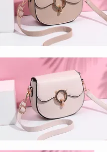 Detail of pink saddle bag with golden cat-eared ring clasp and fine stitching