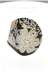 Detailed view of intricate floral sequin embroidery on glossy black leather shoulder bag