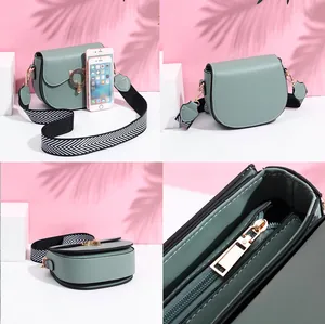 Sage green saddle bag with herringbone strap and vintage round buckle details