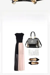 Flat lay of embroidered black patent handbag with golden chain and fashion accessories